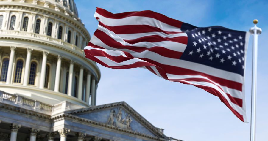 American flag flying in front of white house